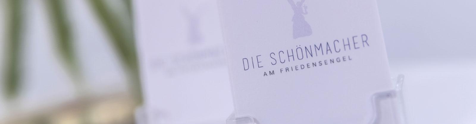 Logo von den Schönmachern am Friedensengel
